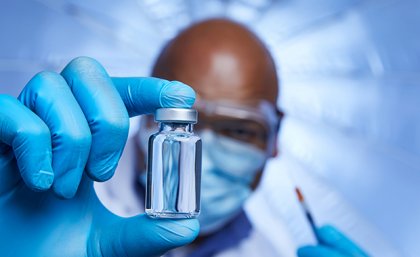 Image: Shutterstock Man holding a vial